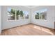 Bright bedroom showcasing large windows that offer abundant natural light and light wood flooring at 8320 Golden Beach Ct, Parrish, FL 34219