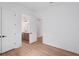 Bedroom boasts an ensuite bathroom, white walls, and wood grain flooring at 8320 Golden Beach Ct, Parrish, FL 34219