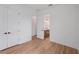 Bedroom boasts an ensuite bathroom, white walls, and wood grain flooring at 8320 Golden Beach Ct, Parrish, FL 34219