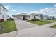 Beautiful single-story home with a modern design, three-car garage, and patterned brick driveway at 8320 Golden Beach Ct, Parrish, FL 34219