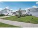 Well-maintained single-story home with a three-car garage, landscaped yard, and sidewalk at 8320 Golden Beach Ct, Parrish, FL 34219