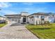 Modern two-story house with paver driveway and landscaped lawn at 8320 Golden Beach Ct, Parrish, FL 34219