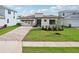 Modern home with a well-manicured lawn, brick driveway, and a sleek design at 8320 Golden Beach Ct, Parrish, FL 34219
