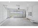 Spacious two car garage featuring an automatic door and concrete floor at 8320 Golden Beach Ct, Parrish, FL 34219