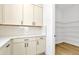 Kitchen features white cabinets and a walk-in pantry at 8320 Golden Beach Ct, Parrish, FL 34219