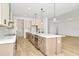 Modern kitchen with island, stainless steel appliances, and light colored cabinets at 8320 Golden Beach Ct, Parrish, FL 34219