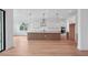 Spacious kitchen featuring an island, white cabinets, pendant lighting, and stainless steel appliances at 8320 Golden Beach Ct, Parrish, FL 34219
