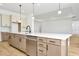 Modern kitchen with island, stainless steel appliances, and light colored cabinets at 8320 Golden Beach Ct, Parrish, FL 34219