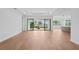 Open living area featuring wood floors, sliding doors to the patio, and an open view of the kitchen at 8320 Golden Beach Ct, Parrish, FL 34219
