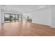 Bright living room with an open floor plan, light wood flooring, and sliding glass doors leading to a patio at 8320 Golden Beach Ct, Parrish, FL 34219