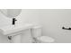 Small bathroom with pedestal sink, toilet, and modern black fixtures at 8320 Golden Beach Ct, Parrish, FL 34219