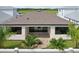 Charming patio area featuring custom stone work, privacy fence, lush palms, and sliding doors for easy indoor/outdoor living at 8320 Golden Beach Ct, Parrish, FL 34219