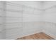Spacious walk-in closet featuring white walls and wire shelving for optimal organization at 8320 Golden Beach Ct, Parrish, FL 34219