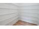 Spacious walk-in closet with white wire shelving and light wood flooring at 8320 Golden Beach Ct, Parrish, FL 34219