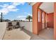 Outdoor patio with seating, palm trees and community views at 16300 Gulf Blvd # 300B, Redington Beach, FL 33708
