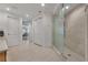 Bathroom featuring walk-in shower, closet, and neutral tile flooring at 16300 Gulf Blvd # 300B, Redington Beach, FL 33708