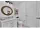 Elegant half bathroom with white vanity, decorative mirror, and modern fixtures, offering style and convenience at 16300 Gulf Blvd # 300B, Redington Beach, FL 33708