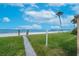 Beautiful beach view with a walking path and lush green space at 16300 Gulf Blvd # 300B, Redington Beach, FL 33708