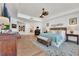 Spacious bedroom featuring hardwood floors, rattan headboard and seating, and bright natural light at 16300 Gulf Blvd # 300B, Redington Beach, FL 33708