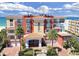 Beautiful condominium building with a red tile roof, palm trees, and ocean views at 16300 Gulf Blvd # 300B, Redington Beach, FL 33708