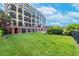 Beautiful condo complex lawn with manicured grass, lush gardens, and elegant architecture at 16300 Gulf Blvd # 300B, Redington Beach, FL 33708