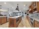 Gourmet kitchen featuring custom island, high-end stainless appliances, wood cabinetry, and marble countertops at 16300 Gulf Blvd # 300B, Redington Beach, FL 33708