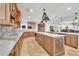 Large kitchen with double islands, custom cabinetry, marble counters, and stainless steel appliances at 16300 Gulf Blvd # 300B, Redington Beach, FL 33708