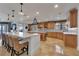 Spacious kitchen featuring custom wood cabinetry, marble countertops and backsplash, and large island with seating at 16300 Gulf Blvd # 300B, Redington Beach, FL 33708