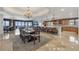 An open-concept living area with a dining table, hardwood floors, and an eat-in kitchen with ocean views at 16300 Gulf Blvd # 300B, Redington Beach, FL 33708