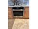 Stainless steel oven with digital display and custom wood cabinetry at 16300 Gulf Blvd # 300B, Redington Beach, FL 33708