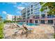 Relaxing condo complex pool and lounge chairs surrounded by lush landscaping at 16300 Gulf Blvd # 300B, Redington Beach, FL 33708