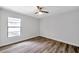 Bright bedroom with ceiling fan and wood-look flooring at 9527 Pebble Glen Ave, Tampa, FL 33647