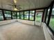 Bright sunroom with backyard access and ceiling fan at 39616 Meadowood Loop, Zephyrhills, FL 33542