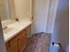 Bathroom vanity with cabinet storage, faucet, and wood-look floor at 5125 Palm Springs Blvd # 1303, Tampa, FL 33647