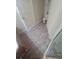 Bathroom with tile flooring, toilet, white door, and glass-enclosed shower stall at 5125 Palm Springs Blvd # 1303, Tampa, FL 33647