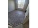 Bedroom with a window and grey wood-look floors at 5125 Palm Springs Blvd # 1303, Tampa, FL 33647