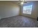 Bright bedroom with a ceiling fan, window, and wood-look flooring at 5125 Palm Springs Blvd # 1303, Tampa, FL 33647