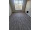 Bedroom featuring a window with blinds and wood-look flooring at 5125 Palm Springs Blvd # 1303, Tampa, FL 33647