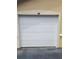 Attached single car garage with white paneled door at 5125 Palm Springs Blvd # 1303, Tampa, FL 33647