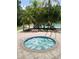 Inviting hot tub surrounded by lush greenery and a view of the community pool at 5125 Palm Springs Blvd # 1303, Tampa, FL 33647