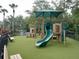 Fun playground area with green turf, slide, and climbing features, ideal for children to play outdoors at 5125 Palm Springs Blvd # 1303, Tampa, FL 33647