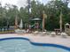 Community pool area with lounge chairs, umbrellas, playground, and comfortable seating options for relaxation and enjoyment at 5125 Palm Springs Blvd # 1303, Tampa, FL 33647
