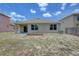 Home's backyard with a spacious lawn at 9538 Highland Ridge Dr, Hudson, FL 34667