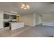 Open concept kitchen with island, dark cabinets, and granite countertops at 9538 Highland Ridge Dr, Hudson, FL 34667