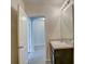 Small bathroom with single vanity and access to hallway at 9538 Highland Ridge Dr, Hudson, FL 34667