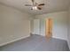 Bedroom with ceiling fan and access to bathroom at 9538 Highland Ridge Dr, Hudson, FL 34667