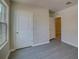 Bedroom with window, closet, and grey flooring at 9538 Highland Ridge Dr, Hudson, FL 34667