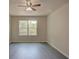 Spacious bedroom with large window and ceiling fan at 9538 Highland Ridge Dr, Hudson, FL 34667