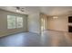 Living room with wood-look floors and access to dining and kitchen at 9538 Highland Ridge Dr, Hudson, FL 34667