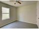 Simple bedroom with window and ceiling fan at 9538 Highland Ridge Dr, Hudson, FL 34667